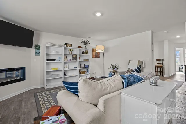 a living room with furniture kitchen view and a table