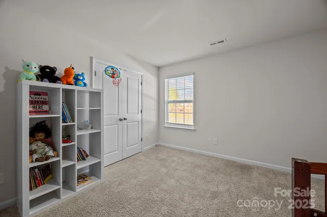 a bed sitting in a bedroom next to a window