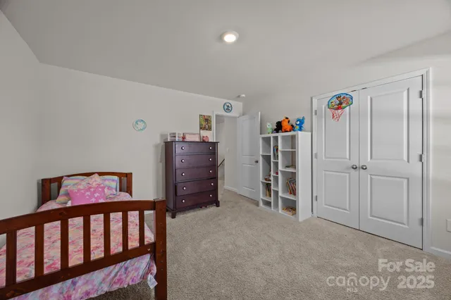 a spacious bedroom with a bed and a cabinets