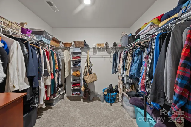 a backyard of a house with barbeque oven table and chairs