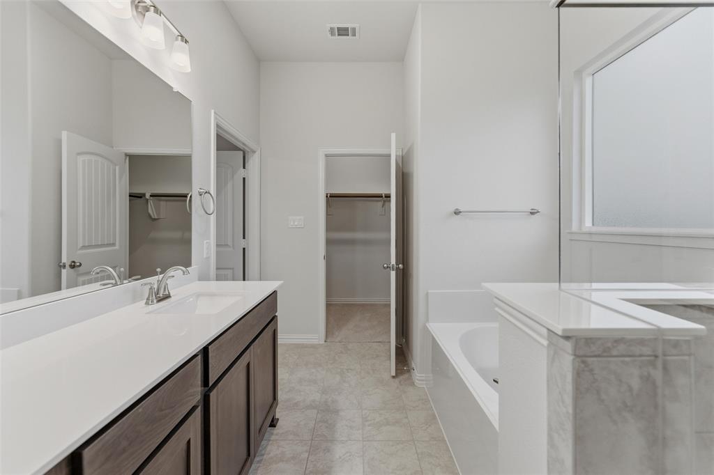 119 Hillview Trail Decatur, TX 76234 - Photo 6 of 30 Bathroom featuring a dual-sink vanity with white countertop, dark wood-finish cabinetry, and brushed nickel fixtures