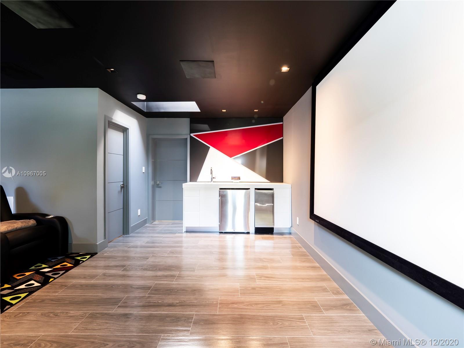 6460 Southwest 133rd Drive Pinecrest, FL 33156 - Photo 19 of 51 Media room with built-in bar, refrigerator, sink and ice-maker. Doors lead to bedroom #1 and full bathroom.