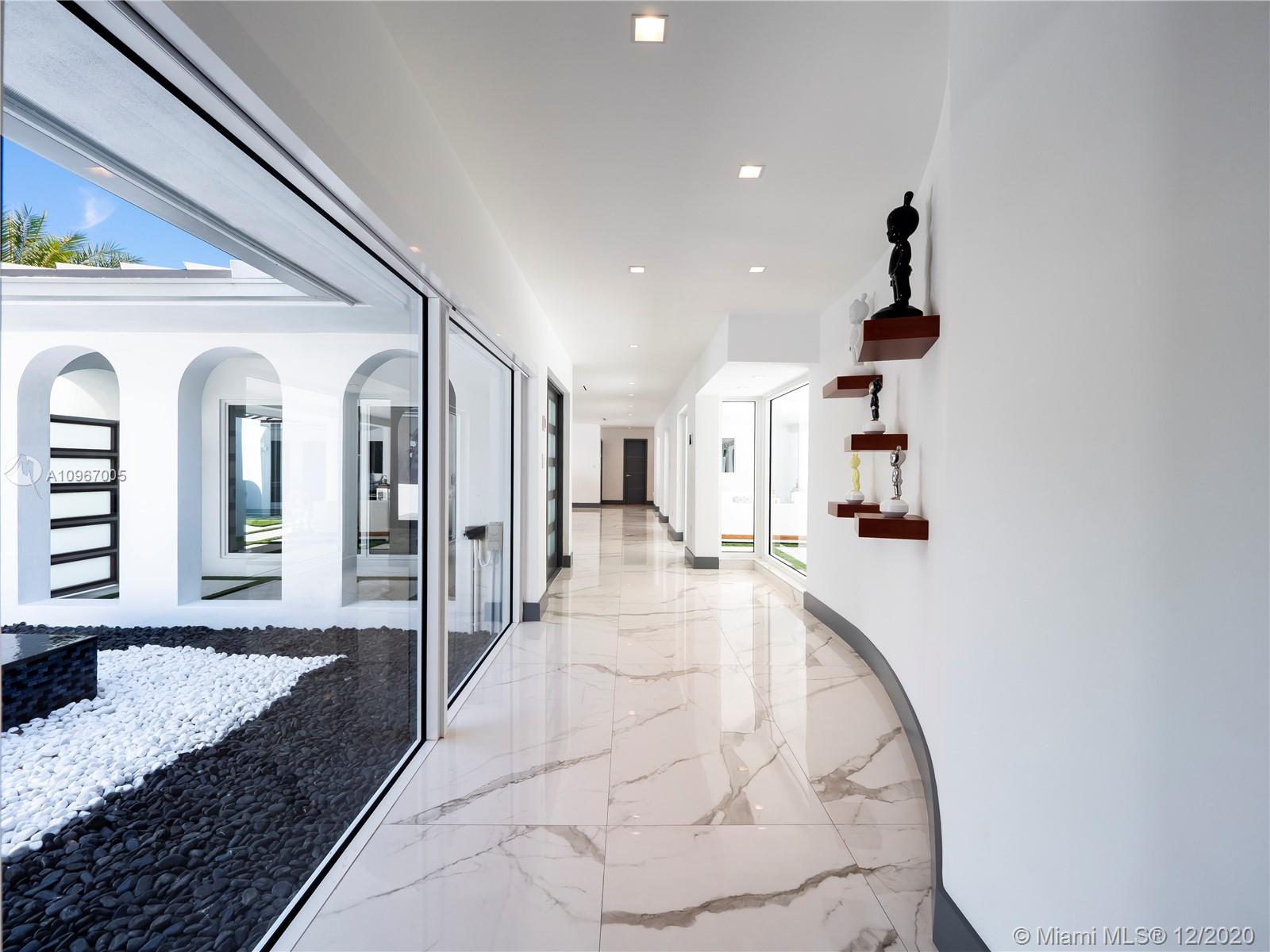 6460 Southwest 133rd Drive Pinecrest, FL 33156 - Photo 5 of 51 Carrara marble-look 30 x 60 porcelain tiles throughout common areas.