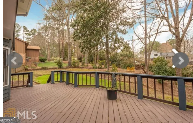 a view of balcony with wooden floor and fence