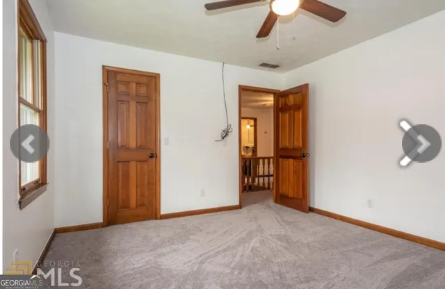 an empty room with windows and closet