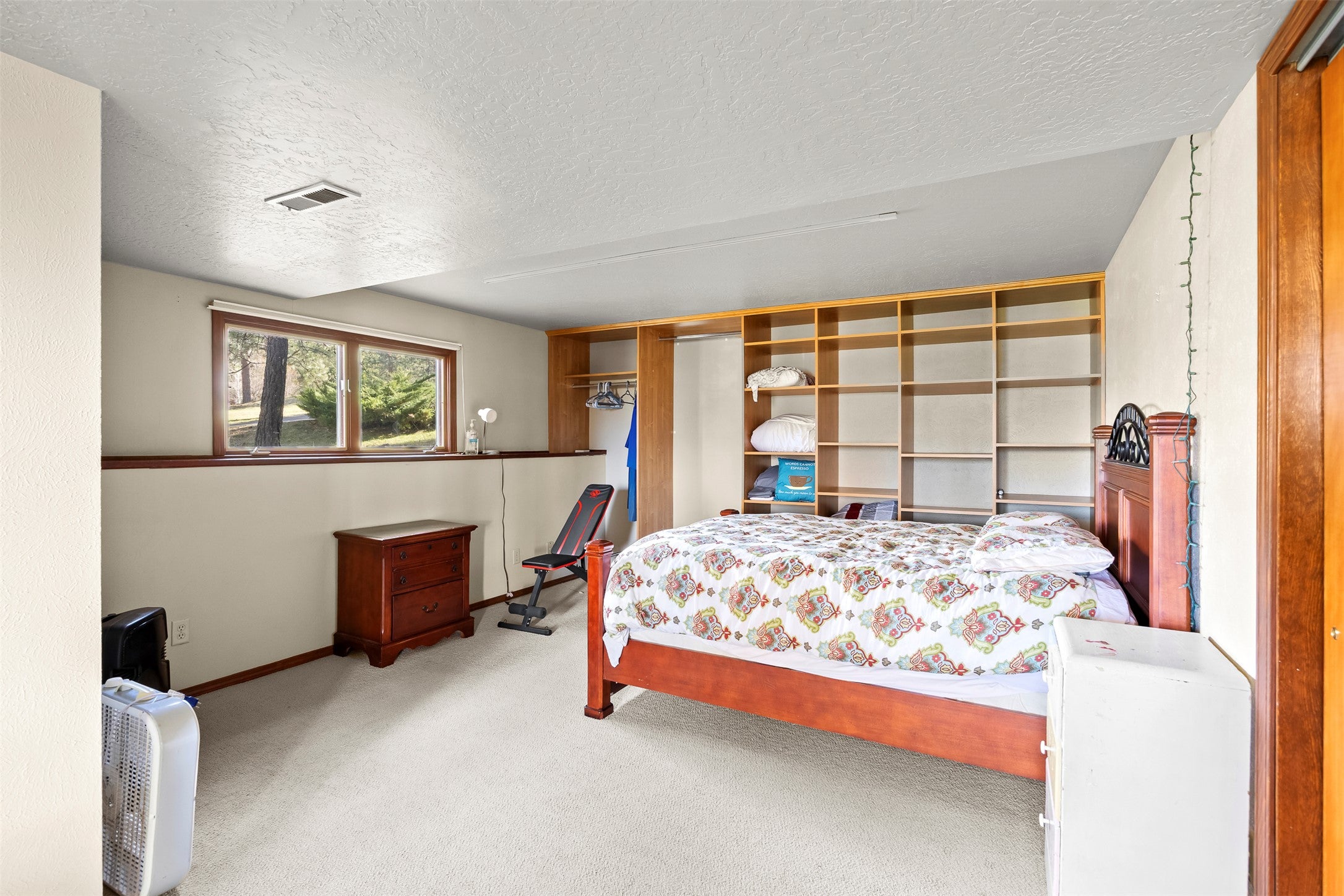 730 Big Flat Road Missoula, MT 59804 - Photo 57 of 59 Bedroom featuring light carpet and a textured ceiling