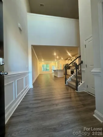 a view of a room with wooden floor