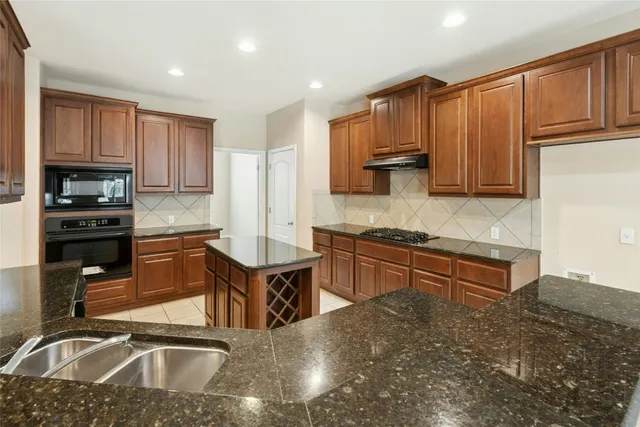 a view of a kitchen with a stove cabinets and wooden floor