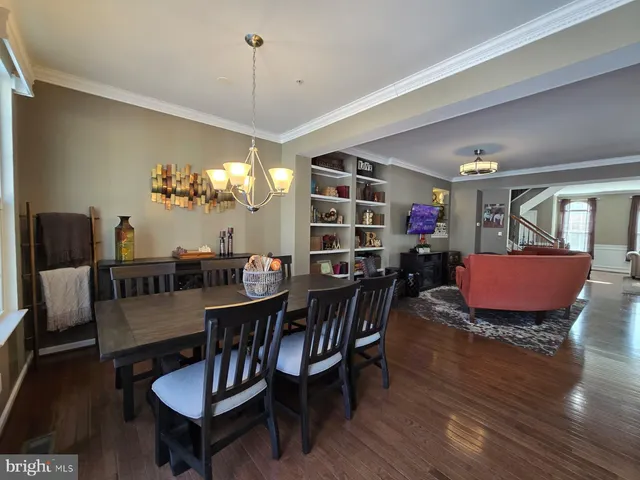 a kitchen with stainless steel appliances kitchen island granite countertop a refrigerator and a stove top oven