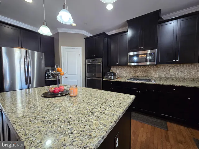 a kitchen with sink cabinets and appliances