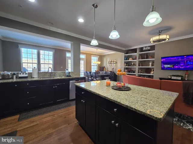 a kitchen with granite countertop a sink and cabinets