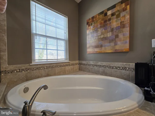 a bathroom with a bathtub a sink a toilet and a shower