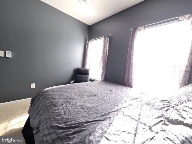 a living room with furniture a flat screen tv and a window