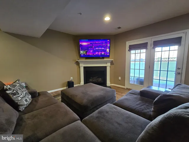 a living room with a couch and wooden floor
