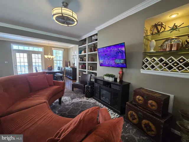 a living room with furniture cabinets and window