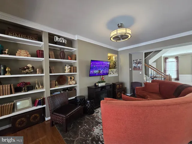 a living room with dining table furniture and a chandelier
