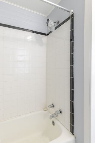 a bathroom with a shower and a bath tub