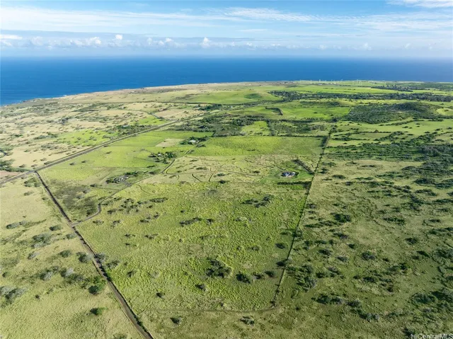a view of a field with an ocean