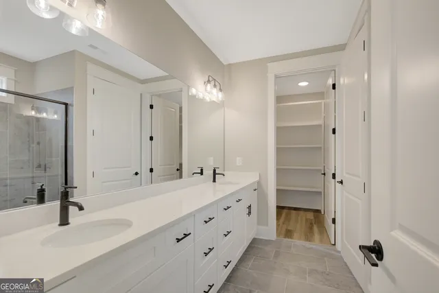a bathroom with a double vanity sink mirror and double