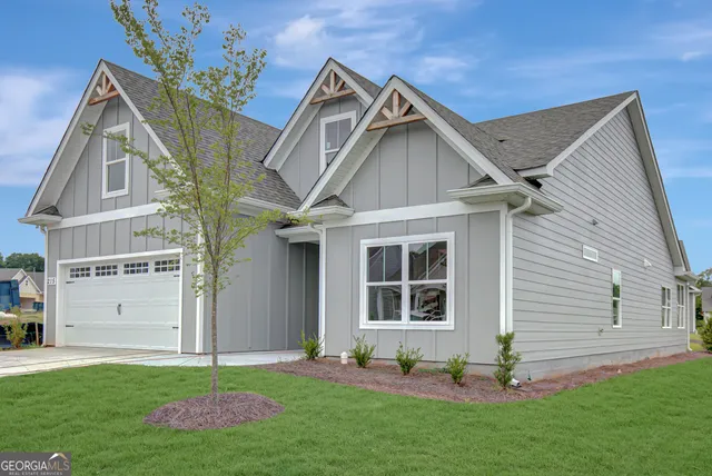 a front view of a house with a yard