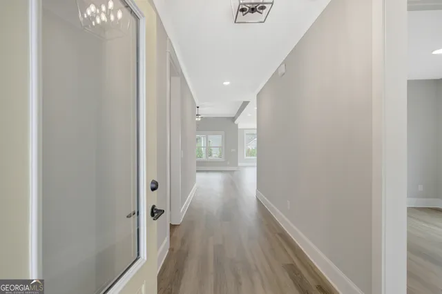 a view of a hallway with wooden floor