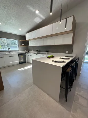 a kitchen with a stove a refrigerator and a sink