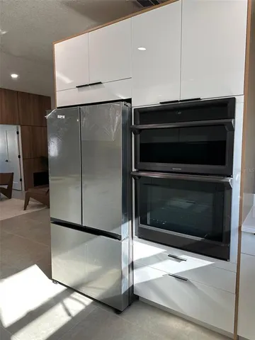 a stove top oven sitting inside of a kitchen