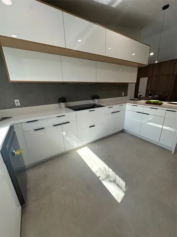 a kitchen with a cabinets and white appliances