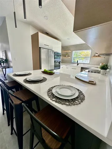 a kitchen with a table chairs and stove