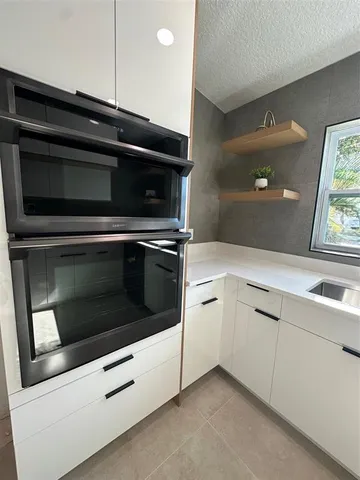 a kitchen with granite countertop cabinets and steel stainless steel appliances