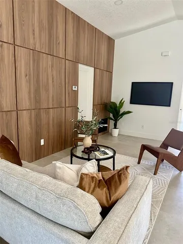 a living room with furniture and a potted plant