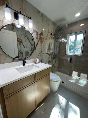 a spacious bedroom with a bed and window