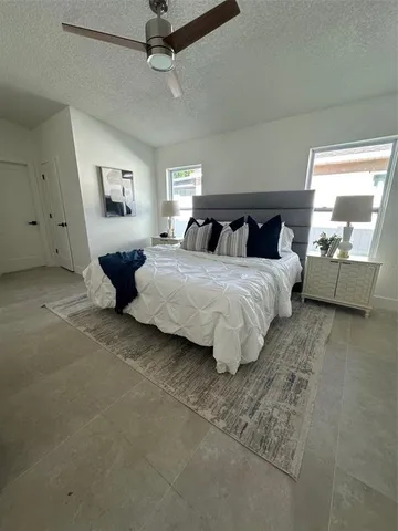 a bedroom with a bed and window