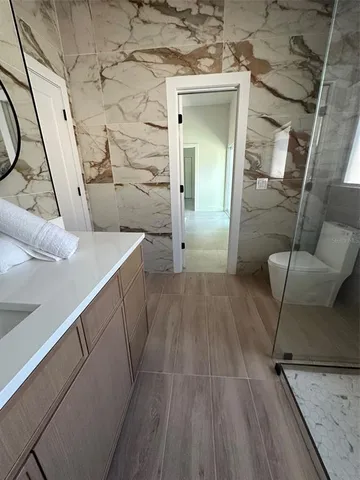 a bedroom with a bed window and dresser