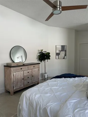 a bedroom with bed and window