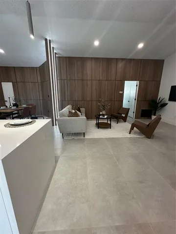 a living room with furniture gym equipment and a window