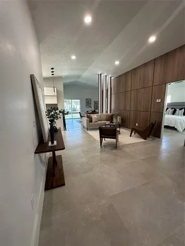 a bed room with a bed and a painting on the wall