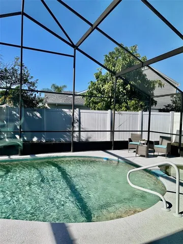 a porch with chairs and potted plant