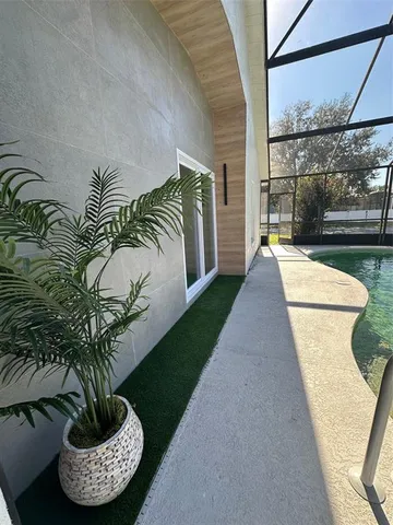 a view of a backyard with table and chairs under an umbrella