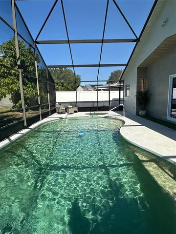 a view of a porch with chairs and potted plant