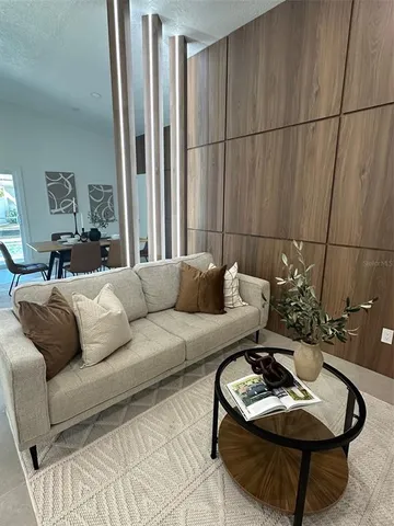 a living room with furniture and a potted plant