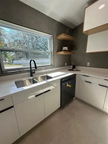 a kitchen with a sink cabinets and appliances