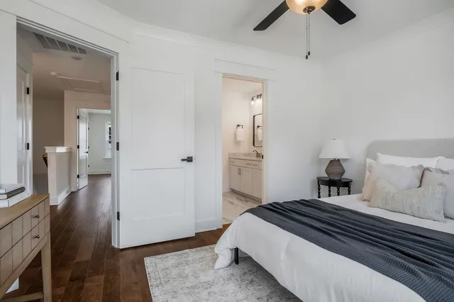 a bedroom with a bed and wooden floor