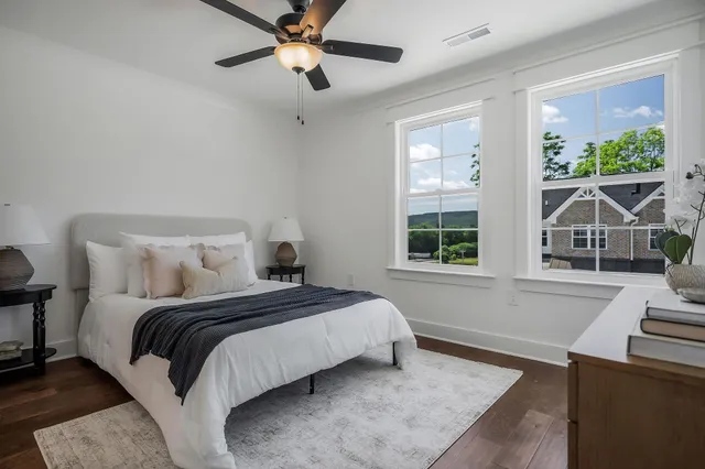 a bedroom with a large bed and a window