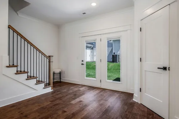 an entryway with hardwood floor