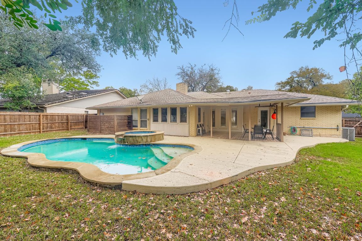 10705 Pinehurst Drive Austin, TX 78747 - Photo 25 of 30 Pool with waterfall hot tub for those unseasonally warm days.