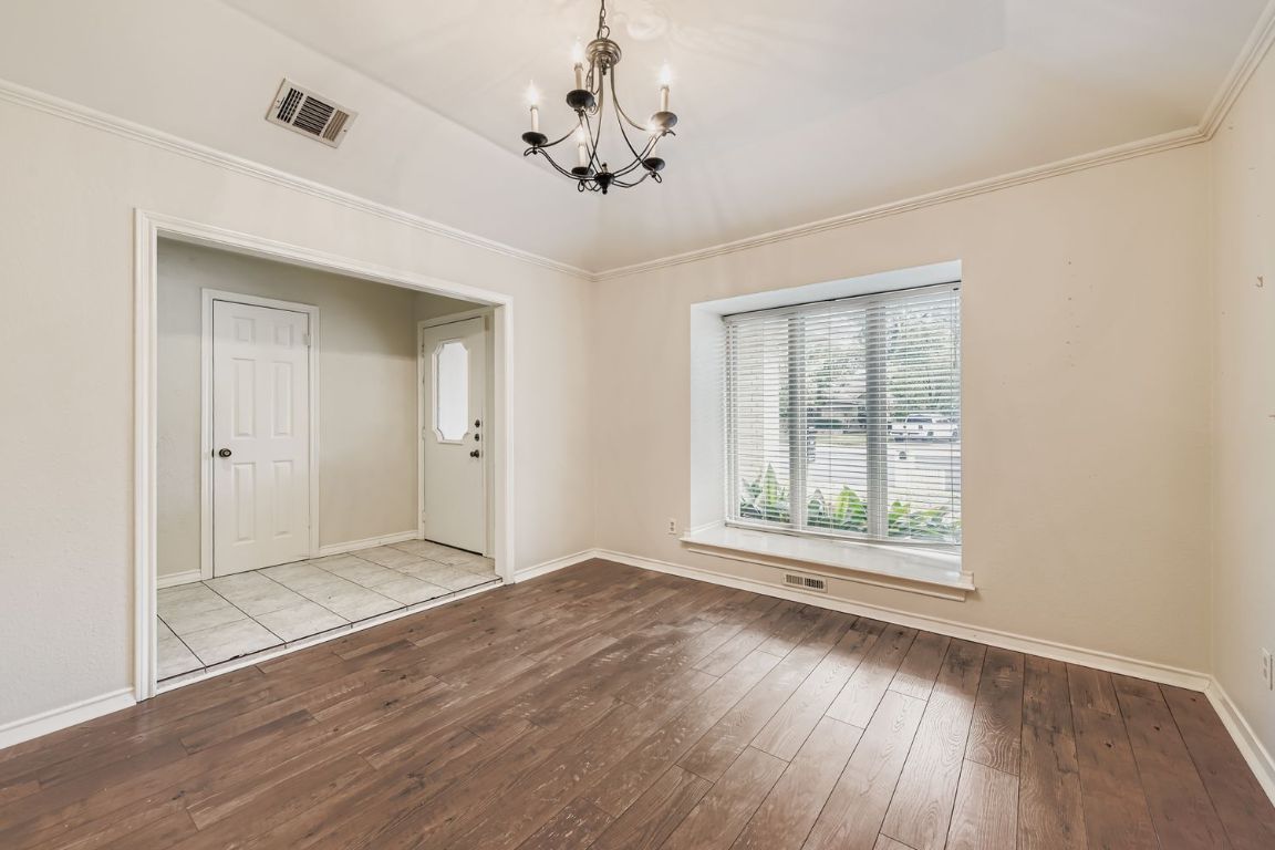 10705 Pinehurst Drive Austin, TX 78747 - Photo 9 of 30 The formal dining room off the entry could easily be used as a home office.