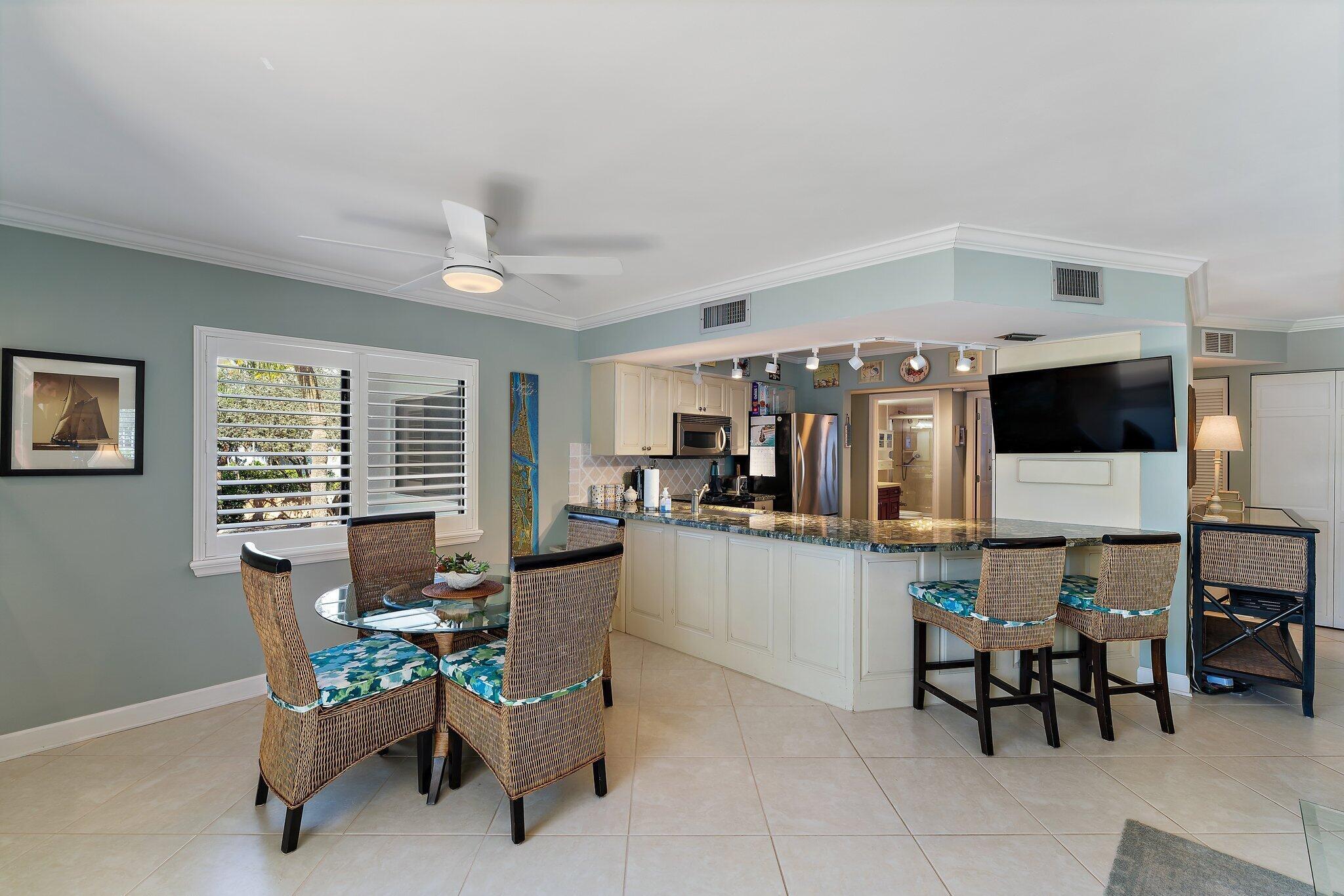 1605 Us-1, Unit B206 Jupiter, FL 33477 - Photo 11 of 35 a living room with furniture and flat screen tv