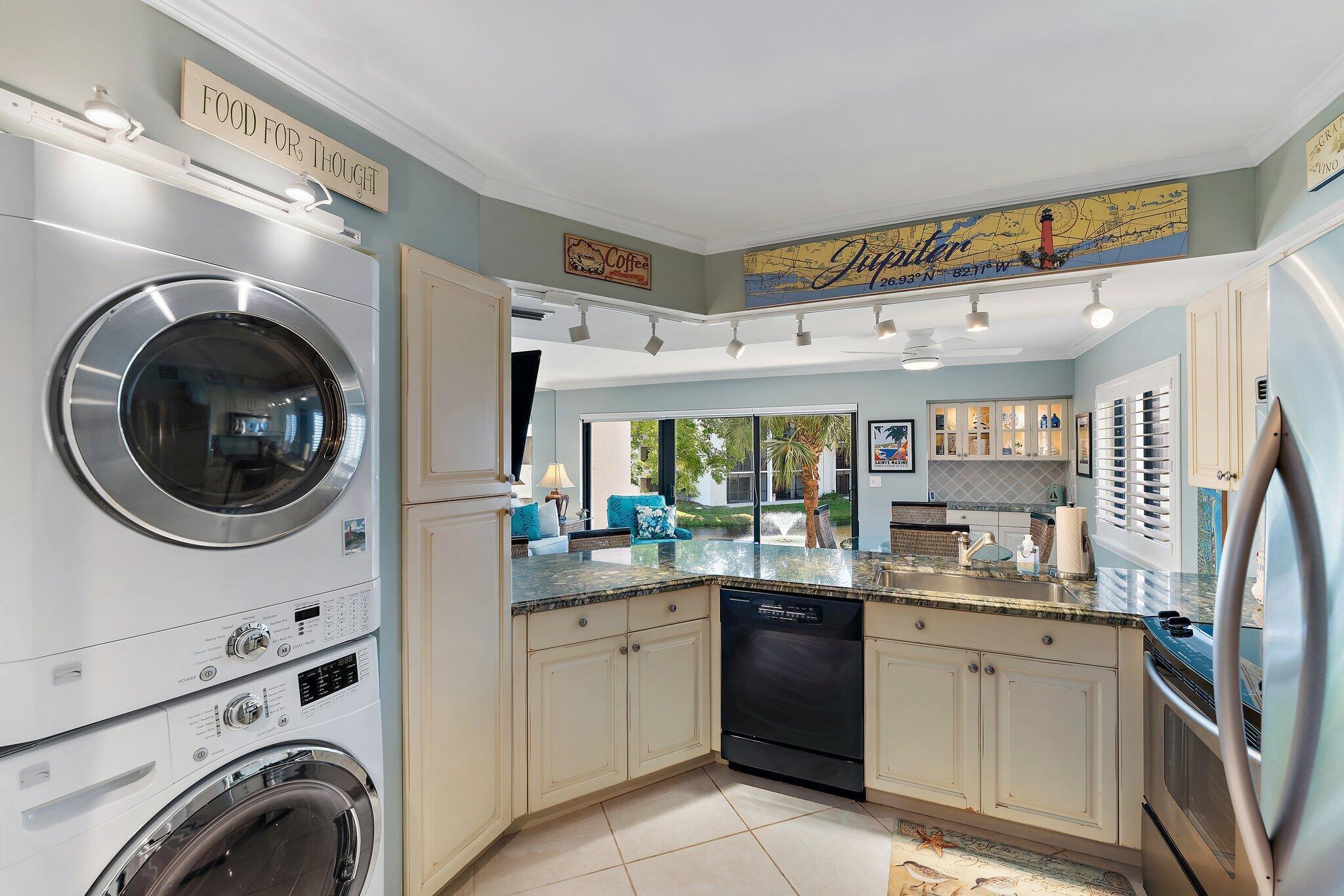 1605 Us-1, Unit B206 Jupiter, FL 33477 - Photo 13 of 35 a kitchen with a stove top oven sink and cabinets