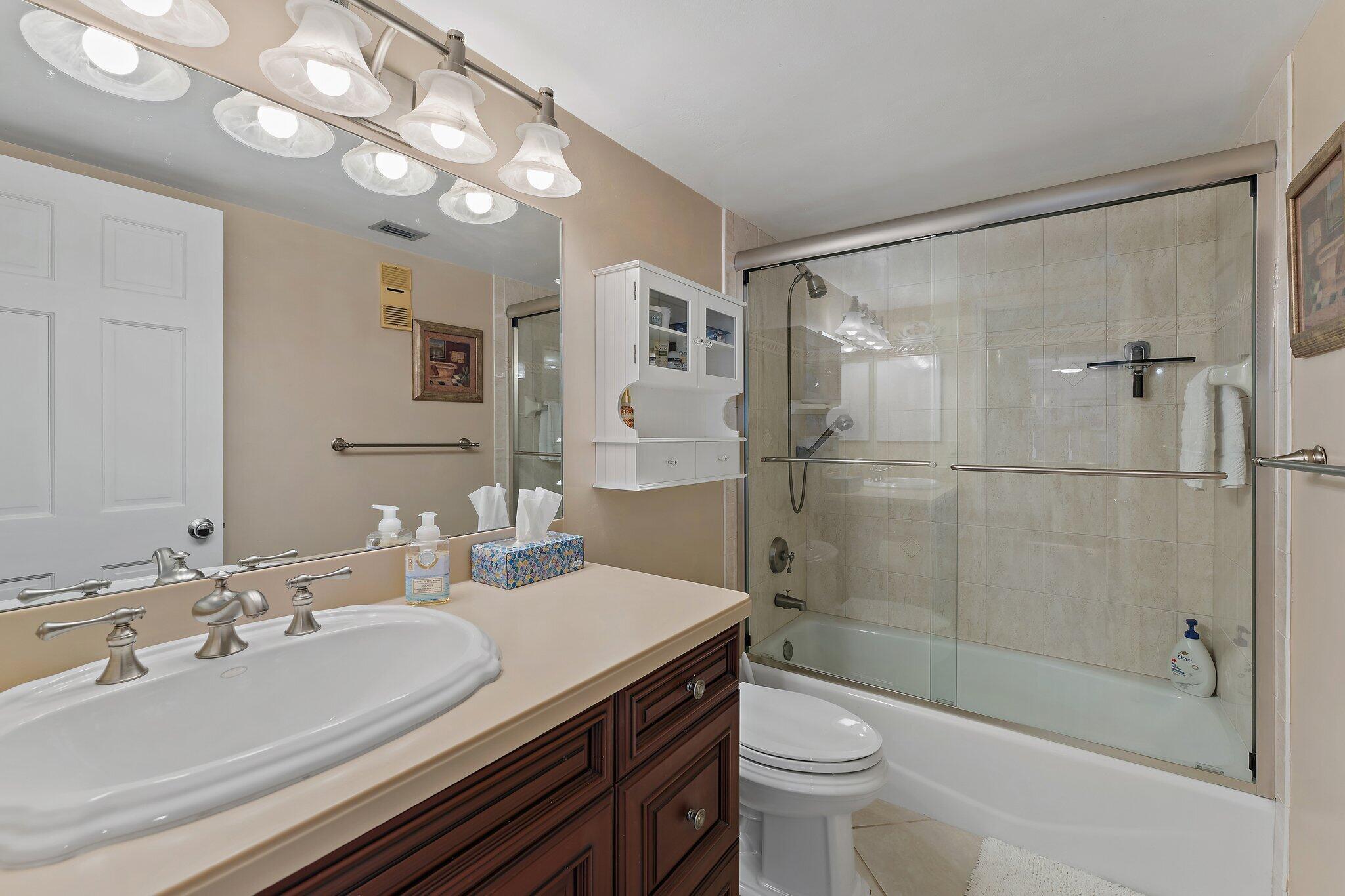 1605 Us-1, Unit B206 Jupiter, FL 33477 - Photo 20 of 35 a bathroom with a sink a toilet and shower